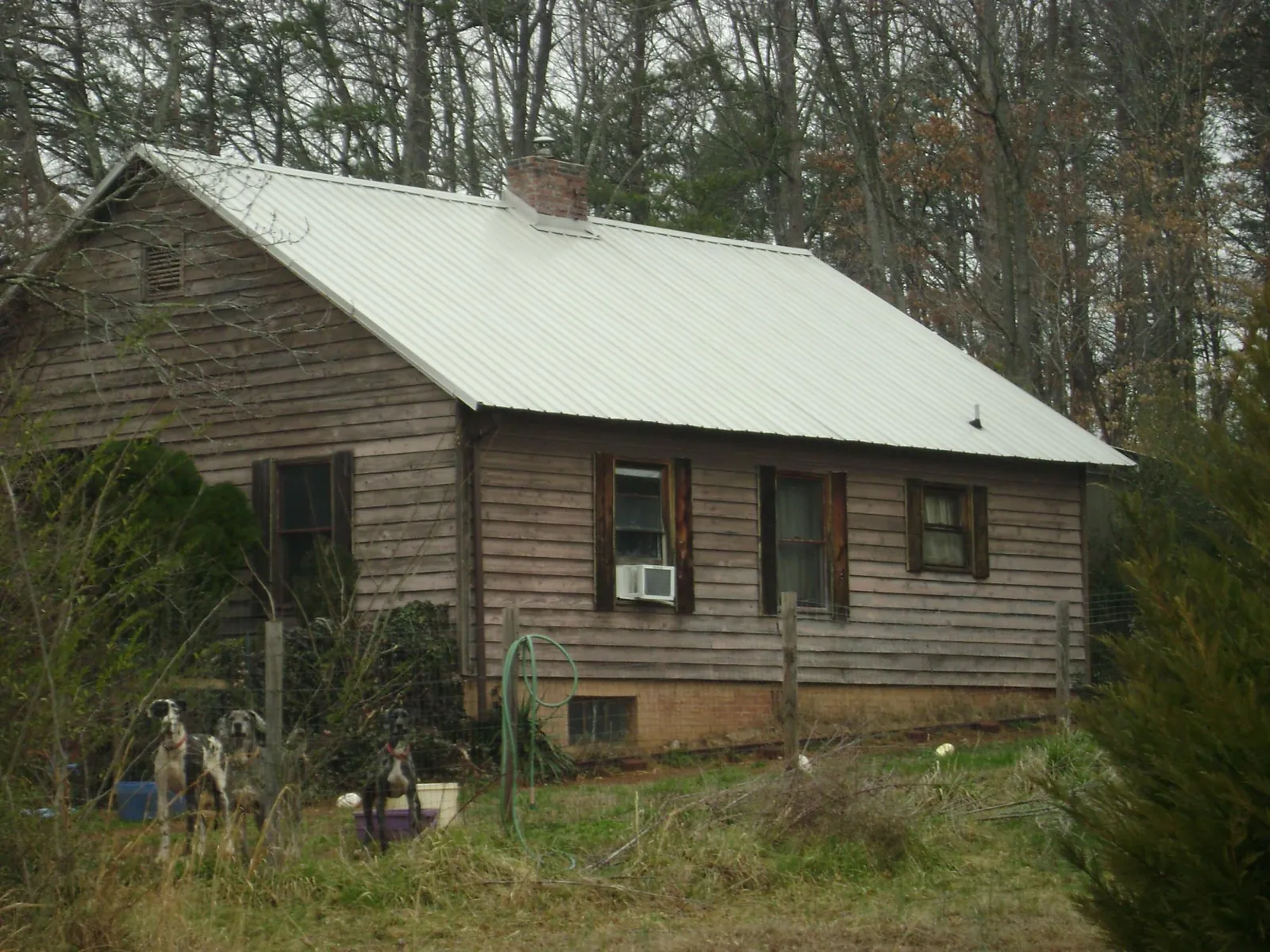White metal roof on an old wood sided farmhouse, from a Asphalt Shingle Roof Repair job in Harrah